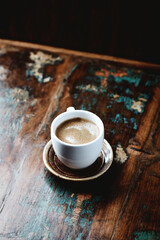 Cup of coffee on rustic wooden background. Copy space.