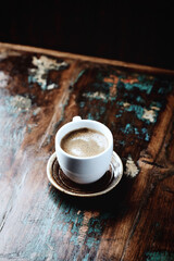 Cup of coffee on rustic wooden background. Copy space.