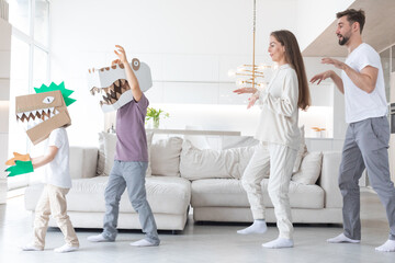 Family playing dinosaurs at home