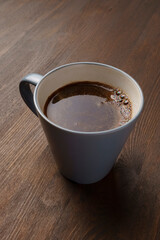 Close up cup of delicious fresh natural coffee on wooden table