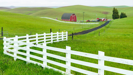 Fototapeta na wymiar Classic Farm in the Palouse with white fence and red barn