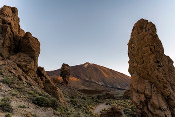 Fototapeta na wymiar Rogues de Garcia hiking trail with Teide volcano in the background. The famous rock formation is called God`s finger. The picture was taken at sunrise.