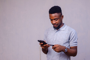 guy using his card and his phone isolated over white background