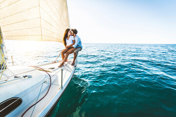 Young couple relaxing on yacht cruise - Two lovers enjoying summer vacation experience on sail boat...