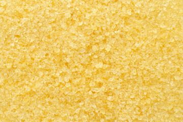 Gelatin, yellow powder top view. Background, texture of crystals of gelatin, close-up. Dry gelatin texture, top view. Dry yellow gelatin powder, top view. Pile of isinglass, top view. - obrazy, fototapety, plakaty