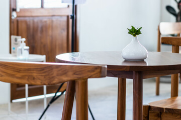 Vintage vase of flowers placed on a wooden table.