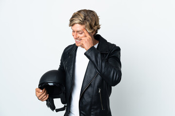 English man holding a motorcycle helmet laughing
