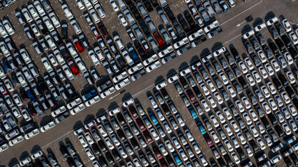 Aerial top view rows of new cars parked in distribution center on car factory, Automobile and automotive car parking lot for commercial business industry to dealership for sale.