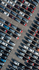 Aerial top view rows of new cars parked in distribution center on car factory, Automobile and automotive car parking lot for commercial business industry to dealership for sale.