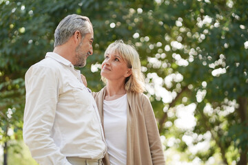 Fototapeta premium Portrait of happy elderly couple hug together, take care and love with good relationship, good health and romantic in the park, retirement insurance and lovely couple concept