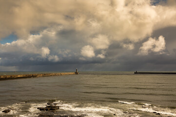 Tynemouth Pier and the Lighthouse guarding the mouth of the River Tyne on a cloudy day