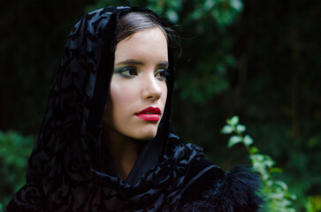 Portrait of young woman in mourning wearing black scarf