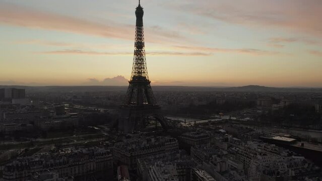 Aerial footage of famous tourist attraction in European metropolis. Eiffel Tower near Seine river. Paris, France