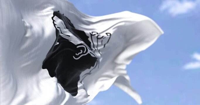 The flag of Corsica waving in the wind on a clear day