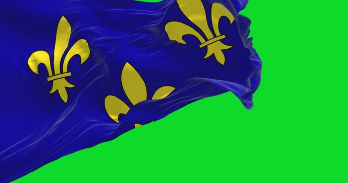 The flag of Ile de France region waving in the wind isolated on a green background