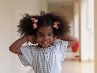 Portrait of cute little African girl smiling with happiness.