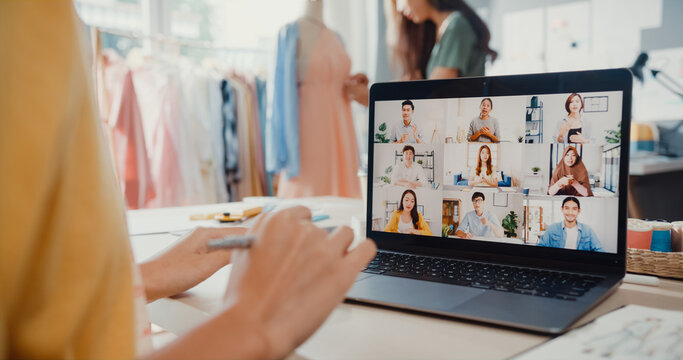 Close-up Young Asia Lady Dressmaker Use Laptop On Meeting With Multi Graphic Designer Team Discuss Sample Create Dress Design New Collection On Desk In Shop. Tailor New Business Startup Concept.