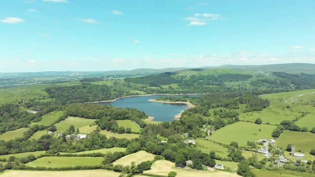 Aerial drone shot of blue lake and green landscapes - Burrator Reservoir, Dartmoor National Park