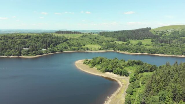 Aerial drone shot of blue lake and green landscapes - Burrator Reservoir, Dartmoor National Park