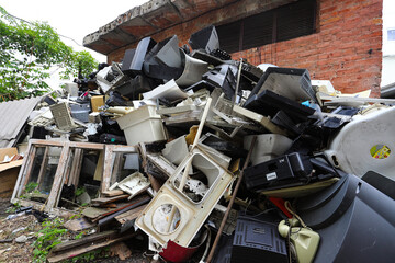 Old office equipment. E-waste devices consist of monitor, printer, desktop and fax, telephone,...