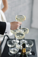 Tower made of glasses with champagne on table, closeup. High quality photo
