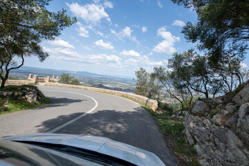 Traveling by car in sunny weather on the serpentine roads of Mallorca.