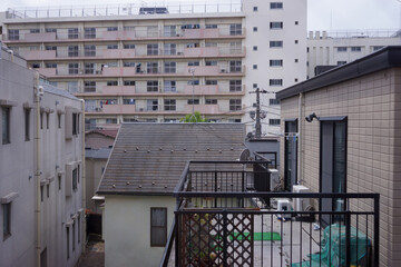 View of typical apartment residential and hotel building at Hatagaya district in Tokyo, Japan with clouds in blue sky background. No people.