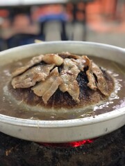 Picture of grilled pork in a charcoal oven