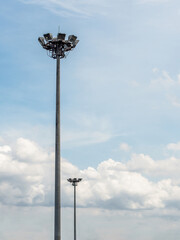 Two sport light stands out on a blue sky background.Lighting for road poles, electric industry, stadium or sports lighting.