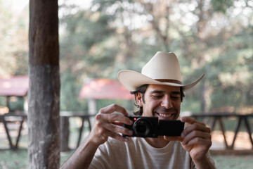A Mexican young man is having fun filming to the camera and to you for an internet video in the nature
