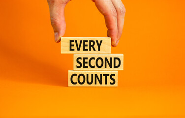 Every second counts symbol. Concept words Every second counts on wooden blocks on a beautiful orange table orange background. Businessman hand. Business, motivational and every second counts concept.