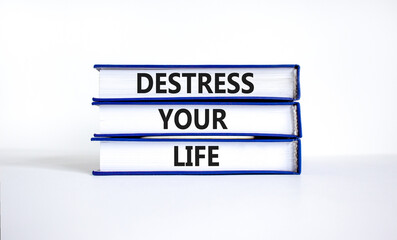 Destress your life symbol. Concept words Destress your life on books. Beautiful white table white...