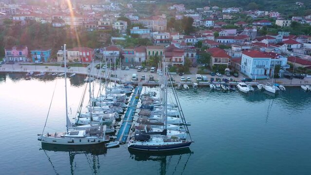 Aerial top-down view of docked sailboats. Top down view of yachts in the marina. Sailboats and regular Boats moured in Palairos Marina Greece. Sailboats and catamarans anchored in the harbour.