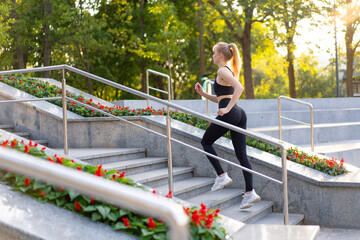 Sport and Fitness. Fit Woman Running up the steps Summer Sunny Morning Caucasian Athletic Female...
