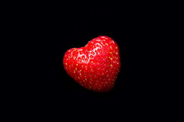 the strawberry lies on a black background
