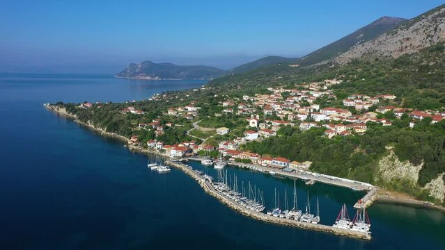 Small marina with catamaran yachts and sailboats in Greece. Kalamos Marina. Beautiful and cozy harbor in Greece. Old fishing village with port on the shore of the Ionian Sea. Travel by boat on the sea