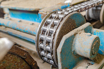 Chain transmission. Chain on old equipment. Industrial background of worn chain device.