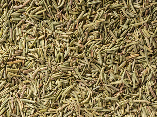 Dried rosemary condiment background, used as a spice in cooking. Organic Dried Rosemary, overhead view. Top view, Flat lay. Organic food, healthy lifestyle. Food flavoring