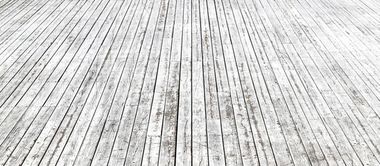 An old wooden pavement painted in white in a sunny day. Photo in perspective with selective focus