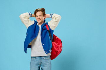 young man in a bomber jacket posing holding his hands behind his head