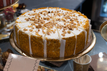 Cake Covered with Cream and Crushed Walnuts Cut into Single Serving Portions