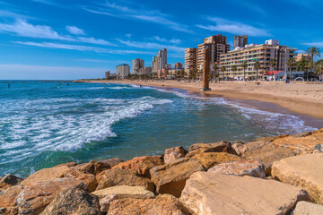 El Campello sandy beach Spain near Benidorm and Alicante with seafront and apartments - obrazy, fototapety, plakaty
