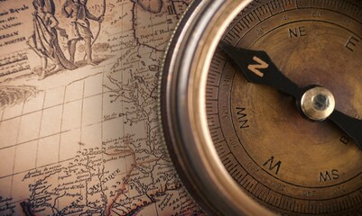 Magnetic old compass on world vintage  map. Travel, geography, navigation, tourism and exploration concept background.