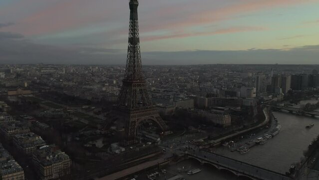 Aerial footage of Pont d Iena over Seine river, traffic on waterfront and famous Eiffel Tower at dusk. Paris, France