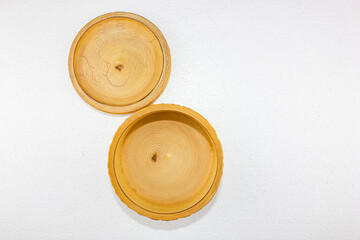 Wooden round carved box on a white background. Wooden box with a place for text.