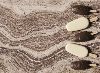 Fototapeta na wymiar White and chocolate ice cream on marble background, cream and brown ice cream on sticks