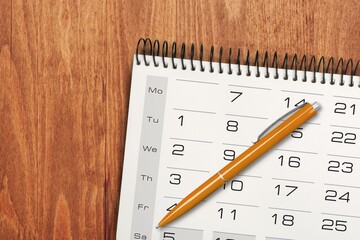 A desktop calendar with a stylish pen, time and business concept