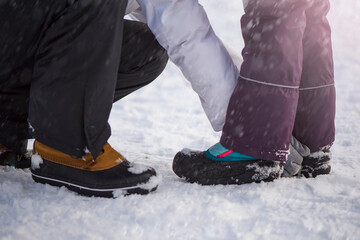 Winter shoes in the snow. Close-up of winter shoes. Children's waterproof shoes for walking in the...