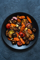 Grilled  vegetables :eggplant,mushrooms,tomatoes,carrot,onion.  Healthy vegetarian meal. Food photography on dark background. Top view.