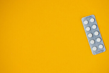 medicine shipping, pills in a package on a yellow background with copy space